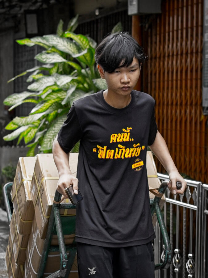 Deliveries · Bangkok, Thailand Young man pushing a handcart loaded with cardboard boxes along a Bangkok street.